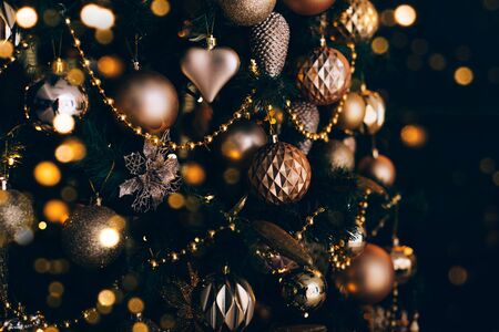 Decorated christmas tree with golden toys on dark background. Christmas concept, 2020. Copy space.の写真素材