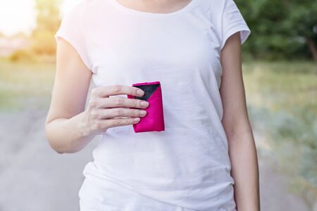 Woman with pink folded drawstring bag on her hand. Cropped.の写真素材