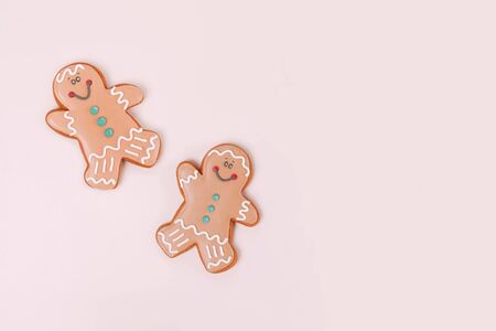 Couple of ginger cookies on pale beige background with copy space. Top view.の写真素材