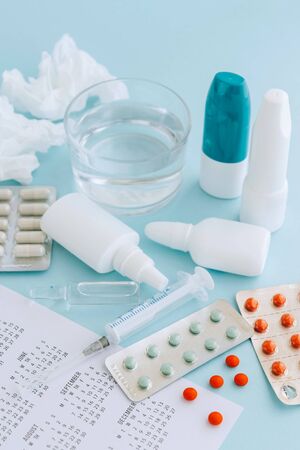 Set of pills and bottles of nose drops for treatment various viruses symptoms. Treatment of seasonal allergic rhinitis or flu. Healthcare concept.の写真素材