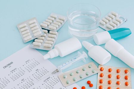 Set of pills and bottles of nose drops for treatment various viruses symptoms. Treatment of seasonal allergic rhinitis or flu. Healthcare concept with copy space.の写真素材