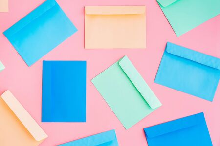 Pattern of colorful correspondence envelopes on pink background. Top view.の写真素材
