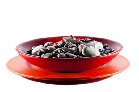stylish modern wooden orange plate full of small pebbleの写真素材