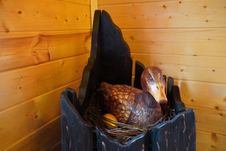 wooden sculpture of a duck with an eggの写真素材