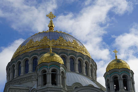 Golden domes of the Naval Cathedral against the blue sky with clouds