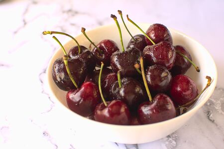 Close-up of fresh cherries inside white bowl