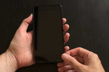 Close -up of woman using smart phone. Woman hand