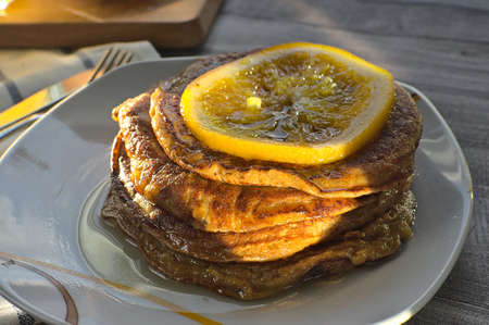 Close up of pumpkin pancakes with orange server on plate