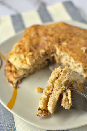 Close up of slice of protein pancake, next to a protein pancake tower split. Healthy breakfast