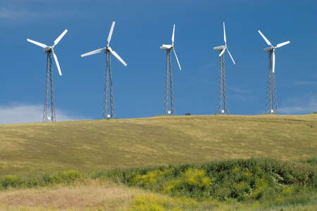 Five wind turbines generating green wind energy.