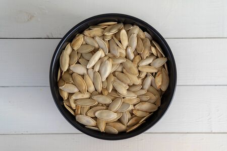Pumpkin seeds in bowl, top viewの写真素材