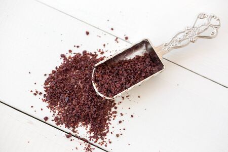 sumac powder on white wooden backgroundの写真素材