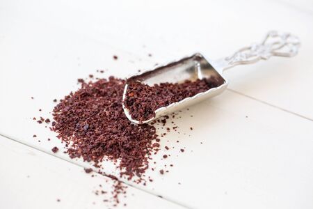 sumac powder on white wooden backgroundの写真素材