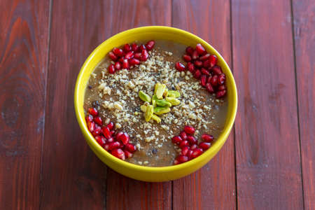 Turkish dessert Ashura, Noah's pudding, with pomegranate seeds and walnuts