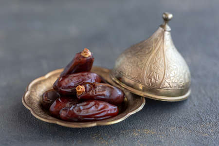 dried date fruit on dark background