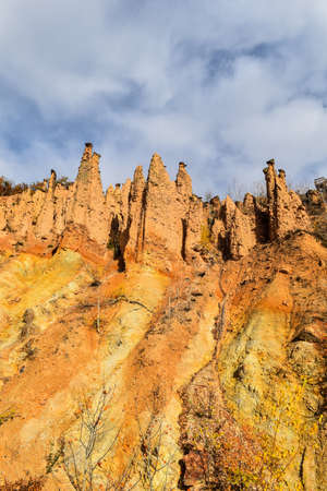 Natural monument of Serbia. Devil's town. Composition of yellow earth texture and blue sky.の写真素材