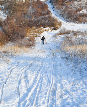 Winter snow scene. Sledding in nature  and winter magic. Frozen roads. Minimal composition.の写真素材