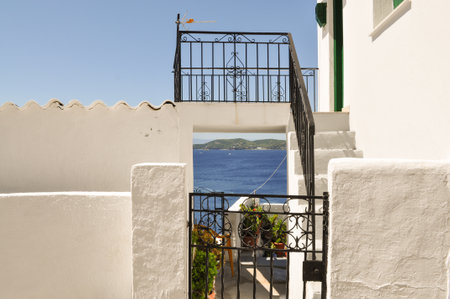 Summer view from the island Skiathos, Greece. White walls and house against blue sky and sea.Creative idea.の写真素材
