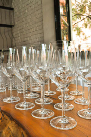 Glasses for white wine waiting for celebration. Creative layout.の写真素材
