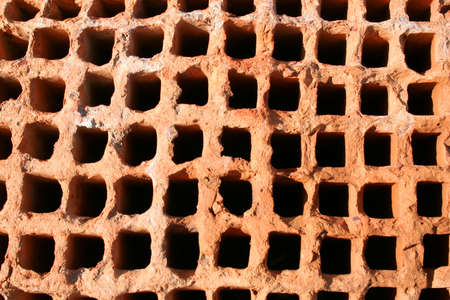 Red brick background with holesの写真素材