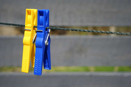 Two colorful clothes pegs on alineの写真素材