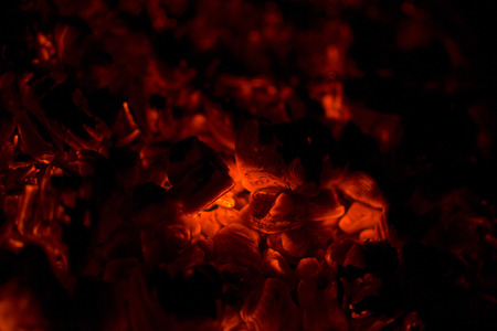 glowing red charcoal close-up on black background