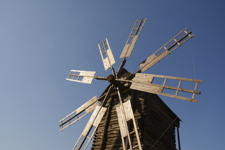 Old wooden windmill against the blue sky