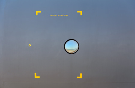 A porthole aboard a military aircraft khakiの写真素材