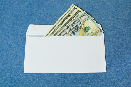 Dollars in a white envelope on a blue backgroundの写真素材