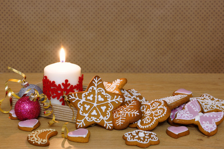 Gingerbread and candle on a wooden table. Background in polka dots.の写真素材
