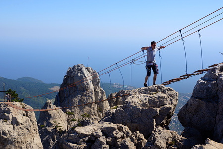 Alupka, Crimea - September 21, 2018. Suspended stairs on Mount Ai-Petri. Crimea. Tourists walk along the hanging stairs between the teeth of Ai-Petri.のeditorial素材