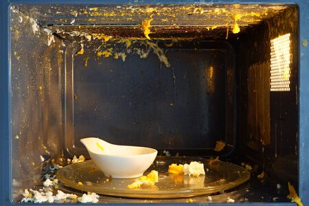 Egg exploded in the microwave. Wrong egg cooking in the microwaveの写真素材