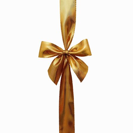 Bow from a gold ribbon. Isolated on white backgroundの写真素材