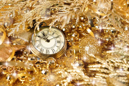 New Year's clock. Decorated with gold tinsel and Christmas decorations. Congratulatory backgroundの写真素材