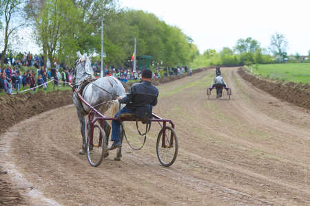 CEADIR-LUNGA/GAGAUZIA - 05.06.2016: Rider on a horse race on hippodrome. Horse carriage racing in Moldova.のeditorial素材