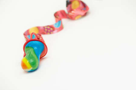 Closeup of Colorful rainbow lollipop swirl and hard sucking fruit candies isolated on white...
