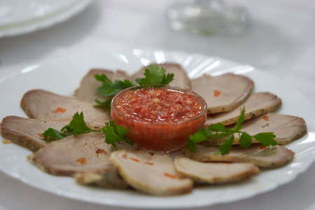 Buffet snacks, canapes placed on plate. Snacks with meat, fruits, cheeses and prawns. To greet...