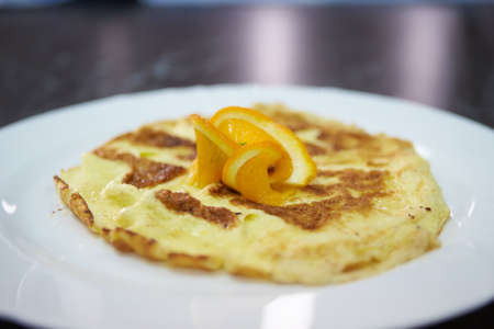 Simple egg omelette with herbs in a plateの写真素材