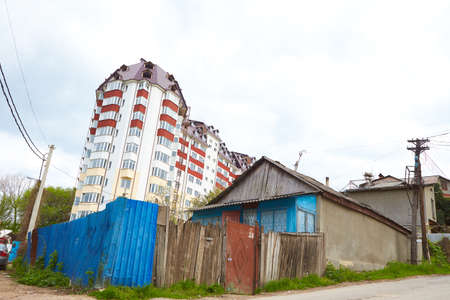 A old house and new building. between poverty and wealth. evolution in constructionのeditorial素材