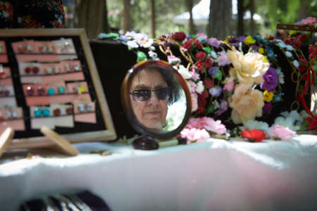 A woman in the mirror at the street expositionのeditorial素材