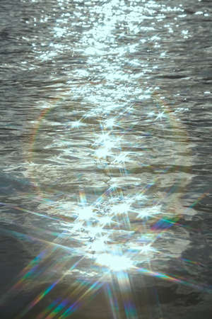 Gold sunlight reflecting in glittering sea. sparkling in waterの写真素材