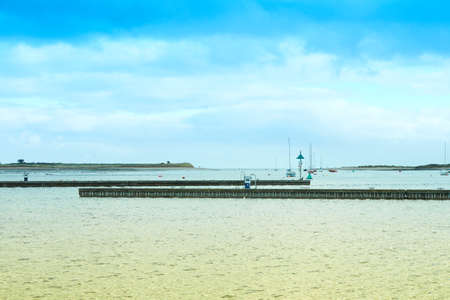 Wooden Pier on Irish Sea in Ireland at mixed color light. Minimalist Viewの写真素材