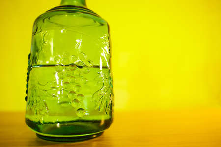 Green water jug on yellow backgroundの写真素材
