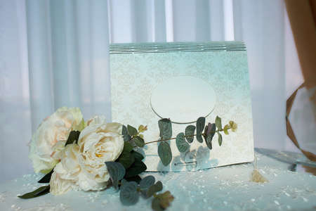wedding elements, guest book and mini bouquet flowers on table. blue background.の写真素材