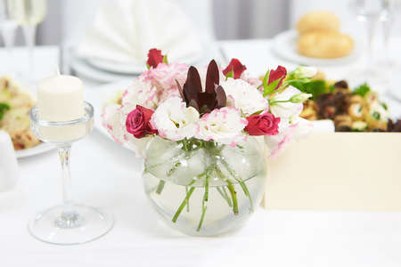 The table of the newlyweds. Interior of restaurant for wedding dinner, ready for guests. Luxury...