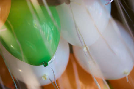 Many colorful helium balloons hanging on the ceilingの写真素材
