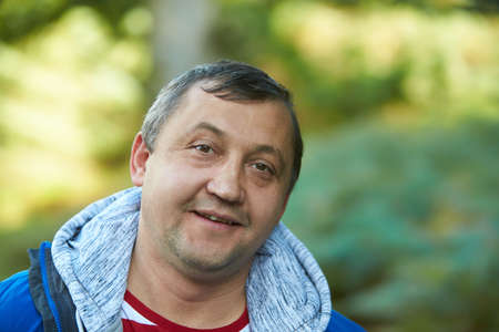 Close up isolated portrait of cheerful happy man in hoodie smiling cute, looking in camera with joyful expression. People sincere emotions lifestyle concept. White background.の写真素材