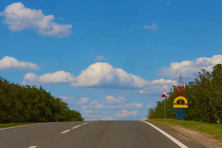 green field and clouds on blue sky in summer day