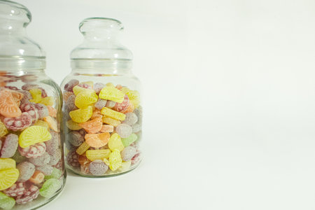 Close Up hard sucking fruit candies in glass bottle isolated on white background. Copy spaceの写真素材