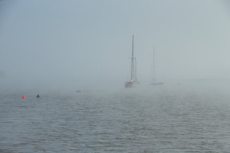 Yachts in the fog. Mist over the sea. Ships in the fog. Yacht parking Sea port.